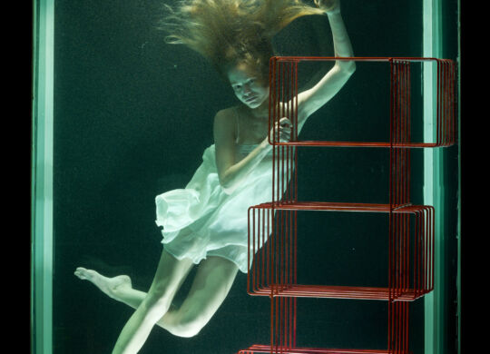 woman-water-with-red-bookcase